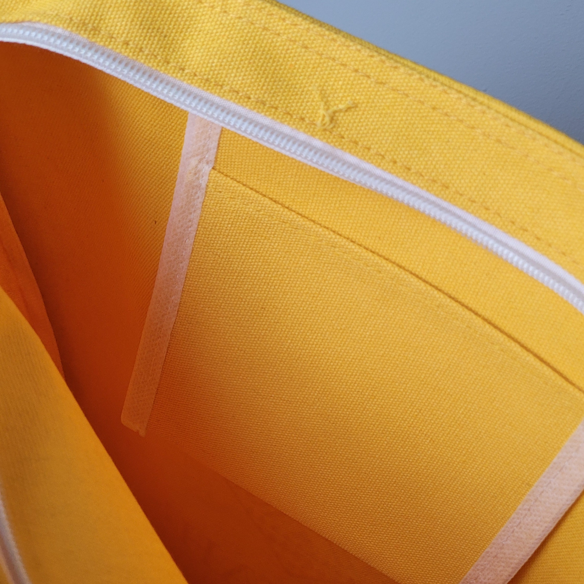 Inside yellow  tote bag showing the zip and the pouch