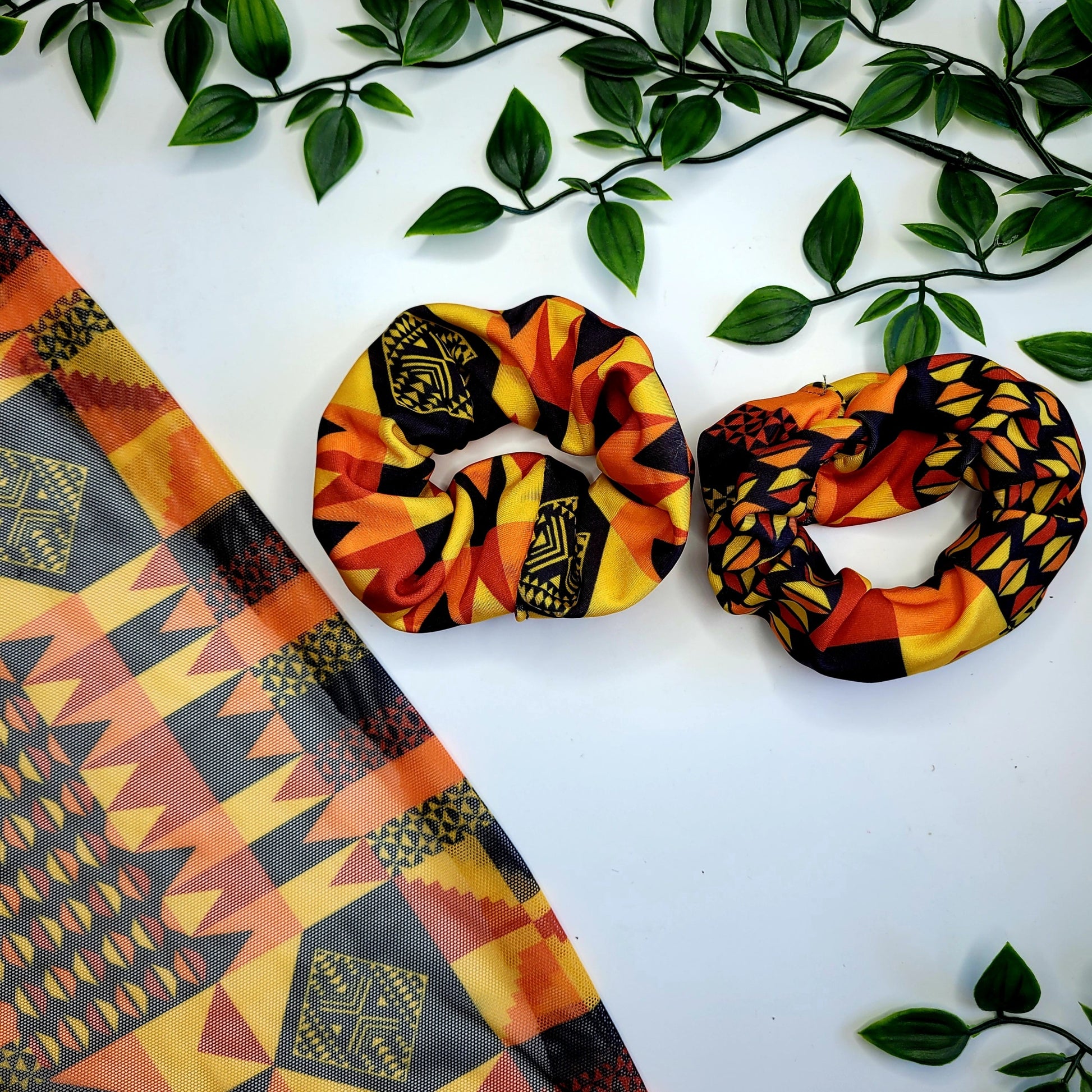 Large hair scrunchie ideal for black girls hair.  A bright vibrant hair bobble in African inspired modern Kente print featuring a bright blue, pink, yellow and purple colour pallet ideal for thick hair including dreadlocks and braids