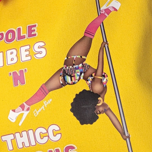 yellow tote bag featuring a black pole dancer wearing bright African inspired Afrocentric garter pole shorts and sports top Bright pink knee socks and clear platform heels in an extended butterfly pose with slogan affirmation pole vibes n thicc vibes