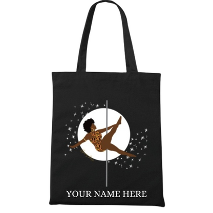 A black tote bag featuring an athletic black girl pole dancer. In a pole pose similar to Martini