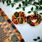 Large hair scrunchie ideal for black girls hair.  A bright vibrant hair bobble in African inspired modern Kente print featuring a bright blue, pink, yellow and purple colour pallet ideal for thick hair including dreadlocks and braids 